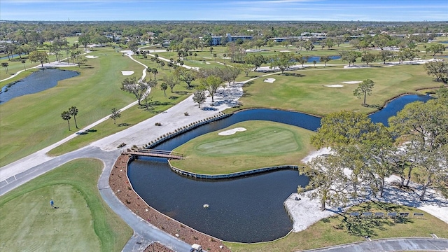 aerial view featuring golf course view and a water view