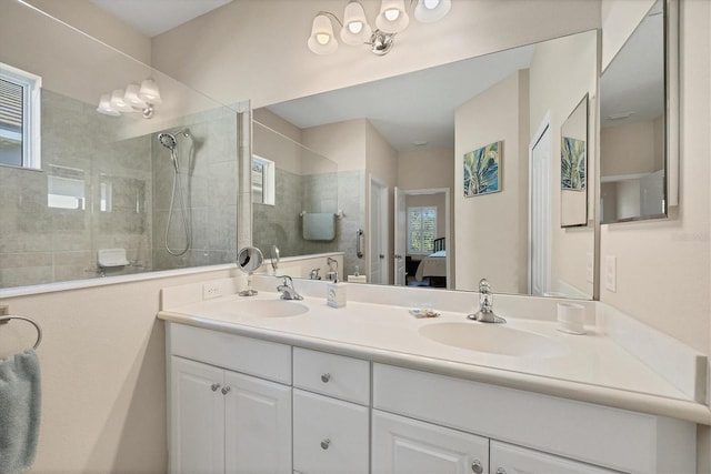 full bathroom featuring a sink, double vanity, walk in shower, and connected bathroom