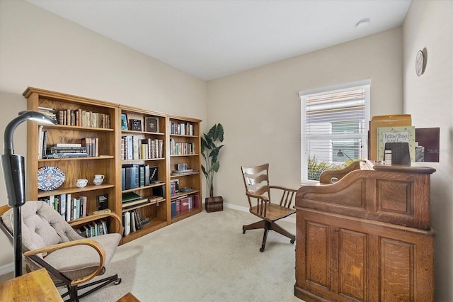 living area with baseboards and carpet