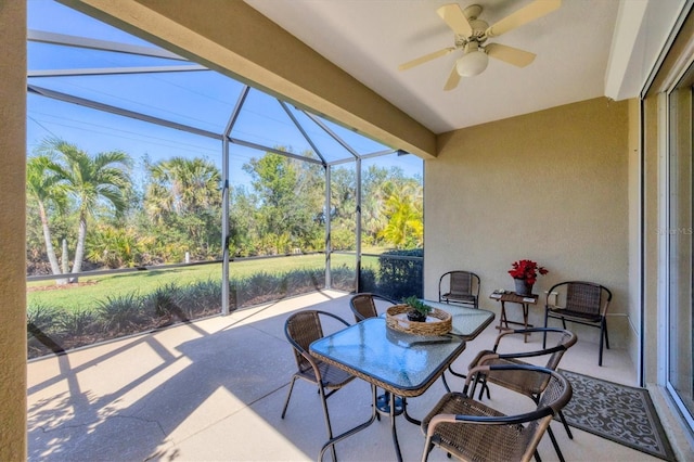 sunroom / solarium featuring ceiling fan