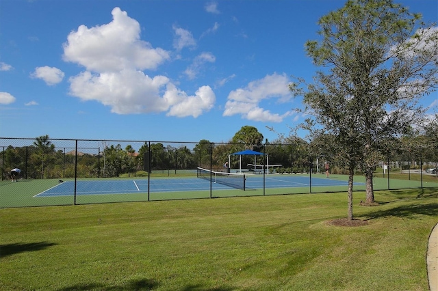 view of sport court featuring a lawn and fence