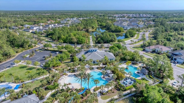 birds eye view of property with a forest view and a water view