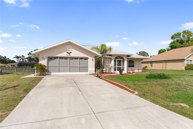 ranch-style house featuring fence, stucco siding, a front lawn, concrete driveway, and a garage