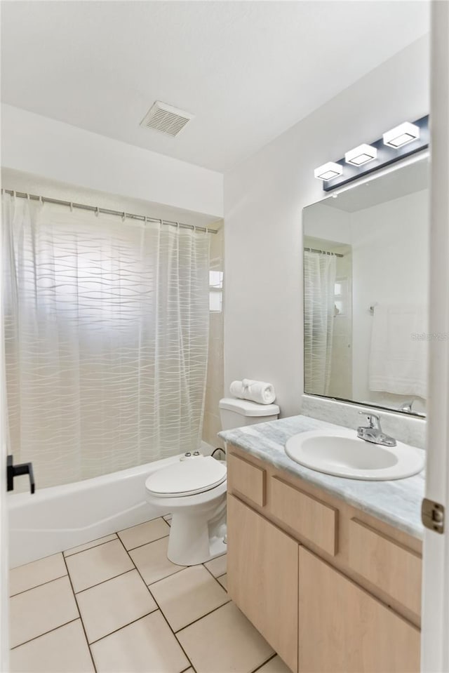 full bathroom with tile patterned flooring, visible vents, toilet, shower / bath combo, and vanity