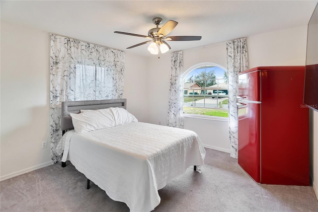 bedroom with carpet flooring, a ceiling fan, and baseboards