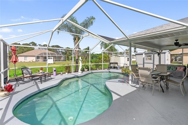 pool featuring glass enclosure, a storage shed, an outdoor structure, and a patio area