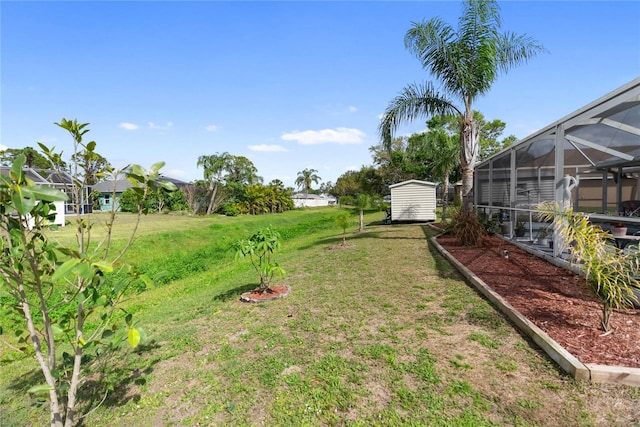 view of yard with a lanai, a storage shed, and an outdoor structure