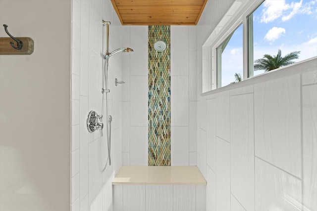 bathroom featuring wood ceiling and tiled shower