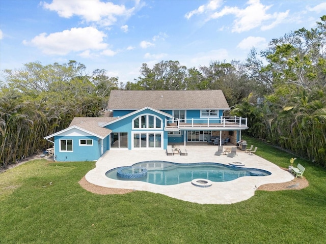 pool featuring a patio, a lawn, and an outdoor fire pit