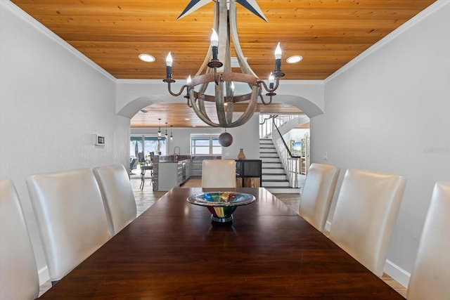 dining space featuring arched walkways, a notable chandelier, wooden ceiling, and ornamental molding