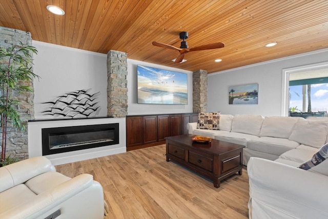 living room featuring a glass covered fireplace, wooden ceiling, recessed lighting, and light wood-style floors