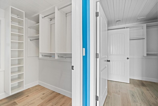 spacious closet featuring visible vents and wood finished floors