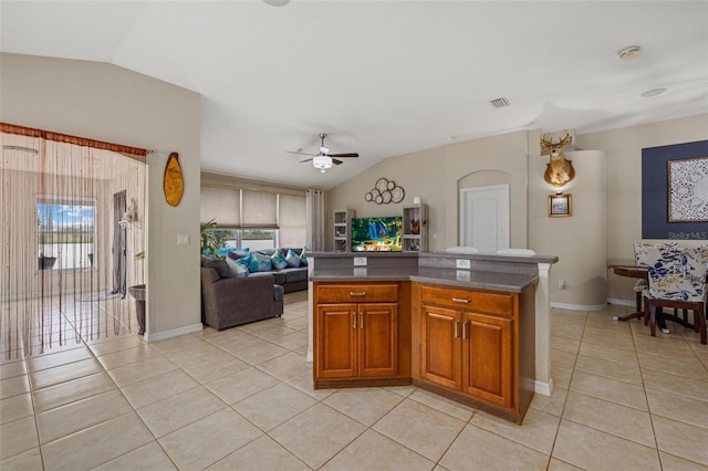 kitchen featuring vaulted ceiling, light tile patterned floors, visible vents, and open floor plan