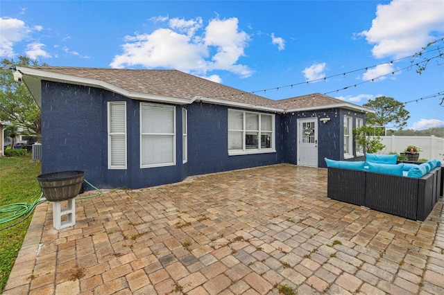 view of patio with an outdoor living space and fence