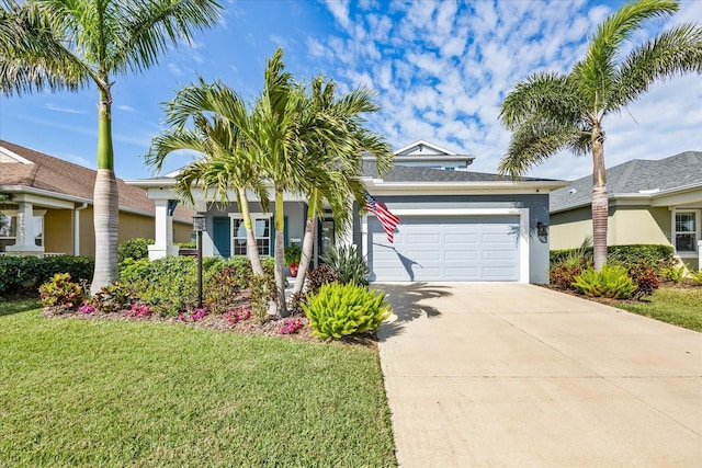 view of front of home featuring a garage, driveway, a front lawn, and stucco siding