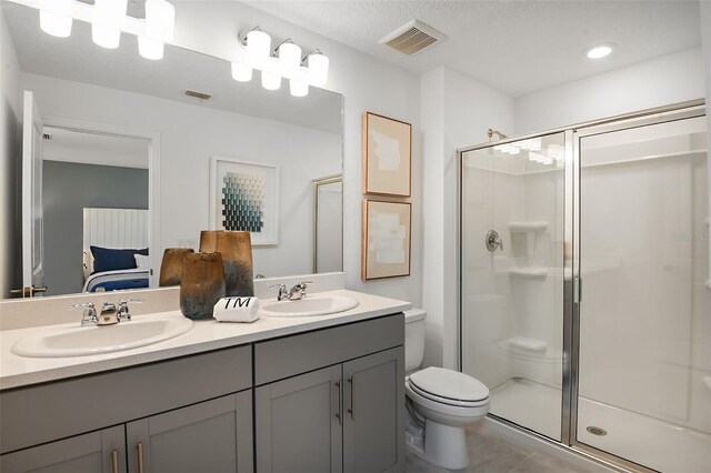 bathroom with visible vents, a stall shower, toilet, and a sink