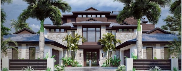 view of front facade with stone siding and an attached garage