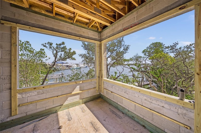 view of patio with a balcony and a water view