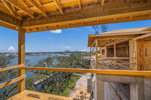 deck featuring an outbuilding, an exterior structure, and a water view