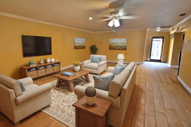 living area with visible vents, baseboards, light wood-style flooring, and crown molding