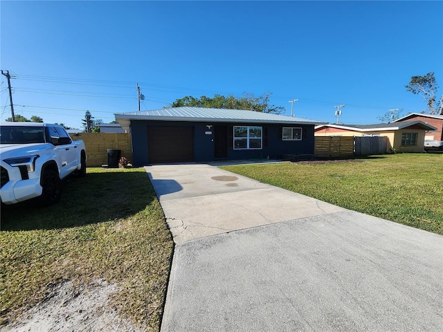 ranch-style home with a front lawn, fence, driveway, and metal roof