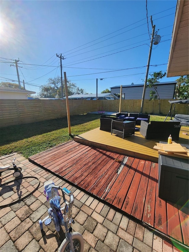 deck with an outdoor hangout area and a fenced backyard