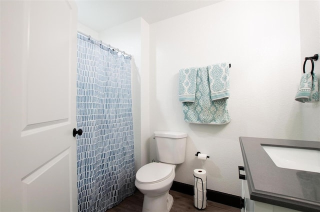 full bathroom with a shower with shower curtain, baseboards, toilet, and wood finished floors