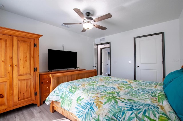 bedroom featuring visible vents, light wood finished floors, and ceiling fan