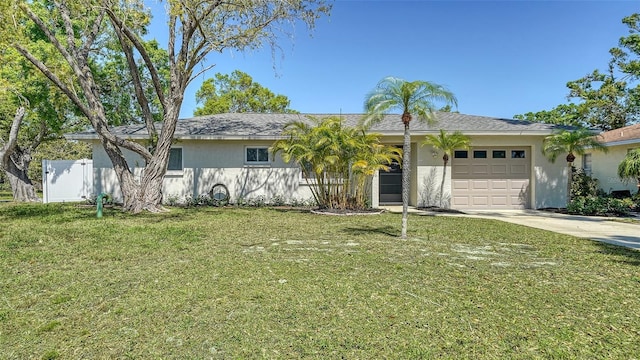 single story home featuring fence, stucco siding, a front lawn, concrete driveway, and a garage