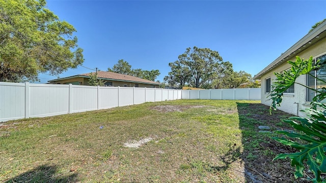 view of yard with a fenced backyard