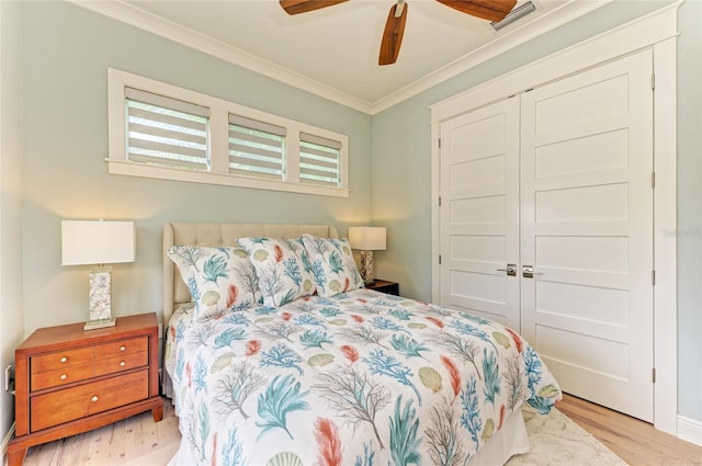 516 Kumquat Dr, Anna Maria, FL 34216 - bedroom with wood finished floors, ornamental molding, a closet, and a ceiling fan