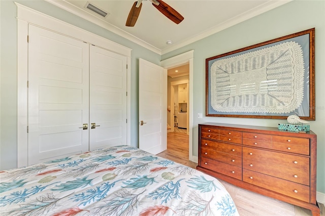 516 Kumquat Dr, Anna Maria, FL 34216 - bedroom featuring light wood-style floors, ornamental molding, a closet, and a ceiling fan