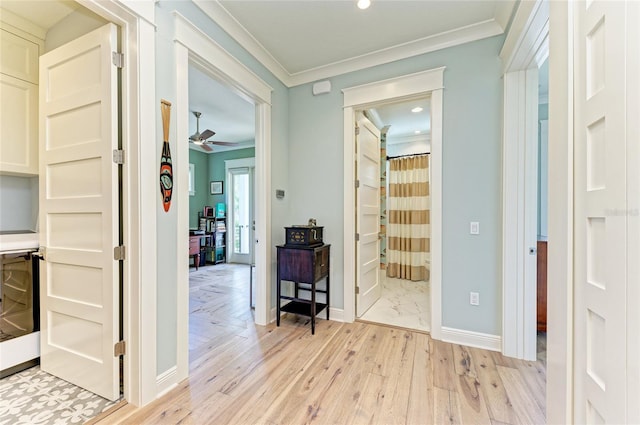 516 Kumquat Dr, Anna Maria, FL 34216 - hallway with light wood finished floors, crown molding, recessed lighting, and wine cooler