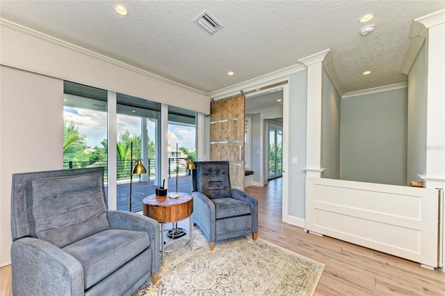 516 Kumquat Dr, Anna Maria, FL 34216 - living area with ornamental molding, wood finished floors, a textured ceiling, recessed lighting, and ornate columns