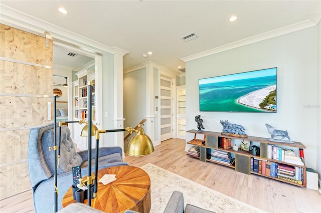 516 Kumquat Dr, Anna Maria, FL 34216 - living room with crown molding, wood finished floors, recessed lighting, and built in features