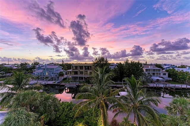 516 Kumquat Dr, Anna Maria, FL 34216 - property at dusk with a water view and a residential view