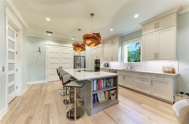 516 Kumquat Dr, Anna Maria, FL 34216 - kitchen with crown molding, appliances with stainless steel finishes, decorative backsplash, a breakfast bar area, and light countertops