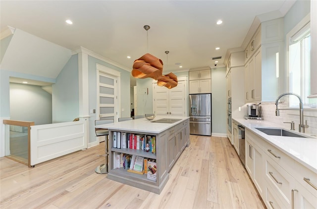 516 Kumquat Dr, Anna Maria, FL 34216 - kitchen featuring stainless steel appliances, light wood-style floors, light countertops, backsplash, and recessed lighting