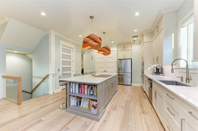 516 Kumquat Dr, Anna Maria, FL 34216 - kitchen featuring stainless steel appliances, light wood-style flooring, light countertops, decorative backsplash, and recessed lighting