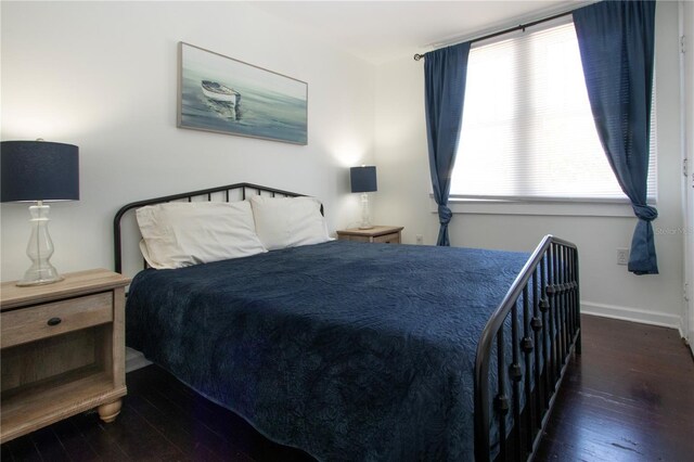 bedroom featuring wood-type flooring and baseboards