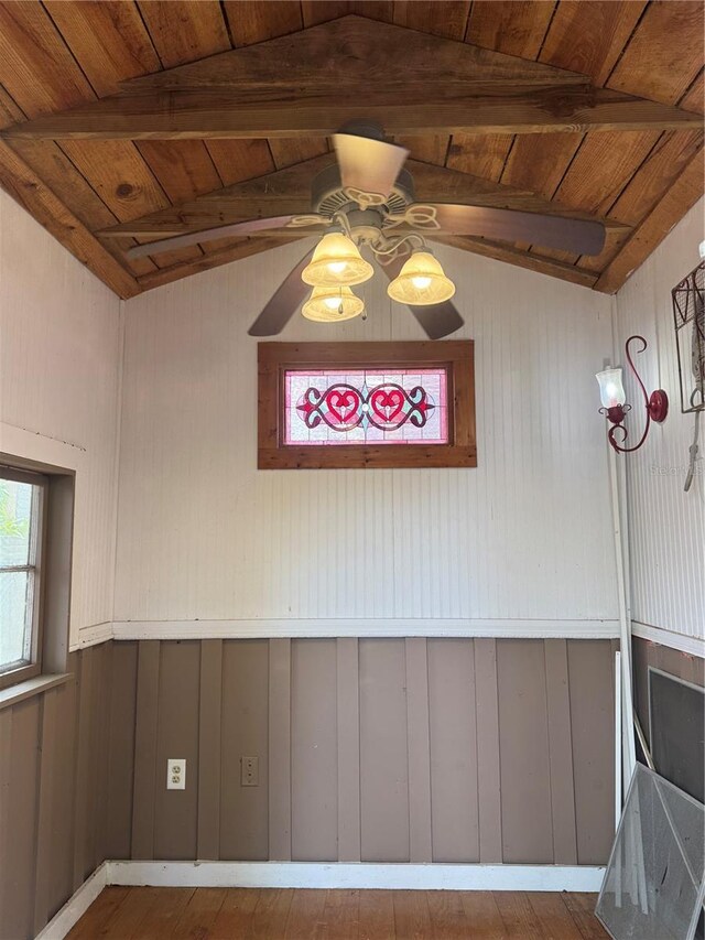 unfurnished dining area with ceiling fan, hardwood / wood-style floors, vaulted ceiling with beams, and wooden ceiling