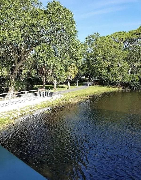 property view of water featuring fence