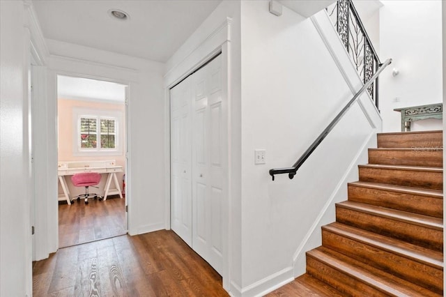 stairs with baseboards and wood finished floors