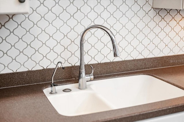 details with dark countertops and a sink