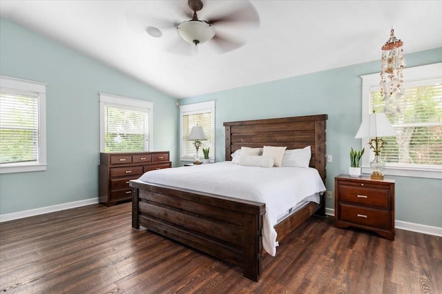 bedroom with dark wood-style floors, ceiling fan, baseboards, and lofted ceiling