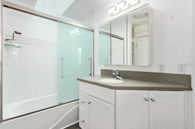 full bathroom featuring vanity and combined bath / shower with glass door