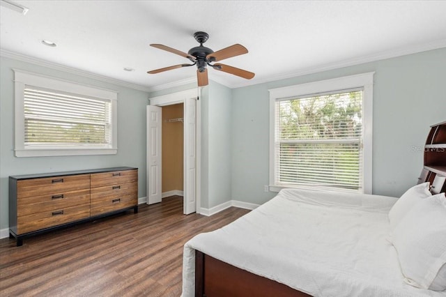 bedroom with crown molding, multiple windows, and dark wood-style floors