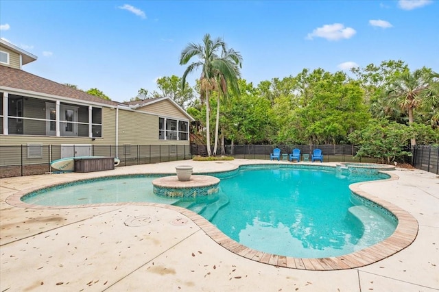 view of pool featuring a patio area, a pool with connected hot tub, and a fenced backyard