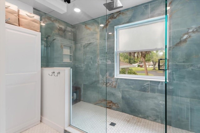 bathroom with tile patterned flooring and a walk in shower