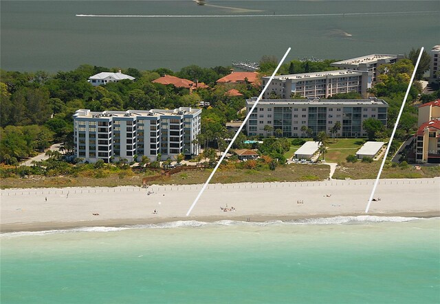 bird's eye view featuring a beach view and a water view